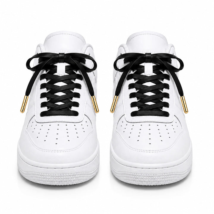 Black faux leather laces with gold metal tips